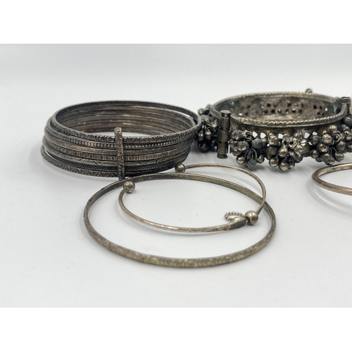 1199 - A collection of white metal bangles and bracelets