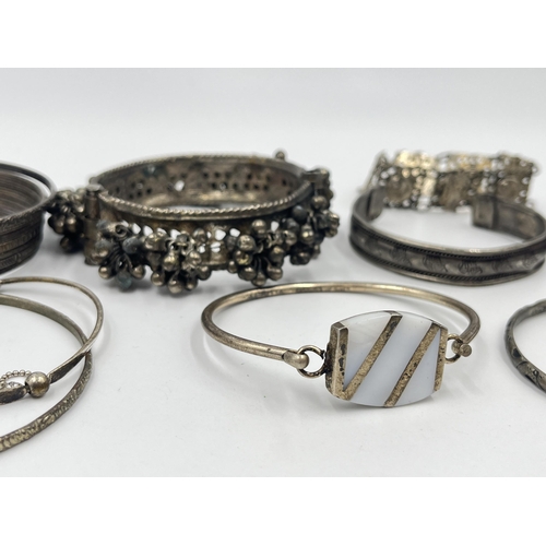 1199 - A collection of white metal bangles and bracelets