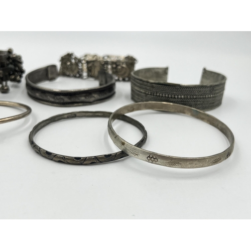 1199 - A collection of white metal bangles and bracelets