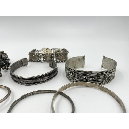 1199 - A collection of white metal bangles and bracelets