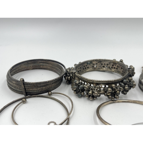 1199 - A collection of white metal bangles and bracelets