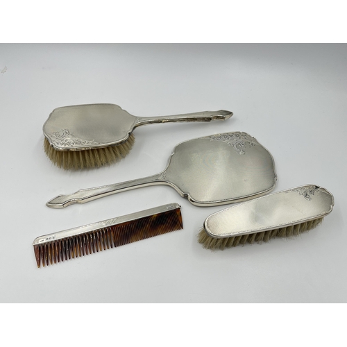 1248 - A cased sterling silver four piece dressing table set, hallmarked Birmingham 1954/55 - approx. gross... 