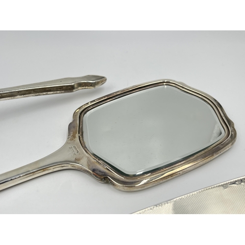 1248 - A cased sterling silver four piece dressing table set, hallmarked Birmingham 1954/55 - approx. gross... 