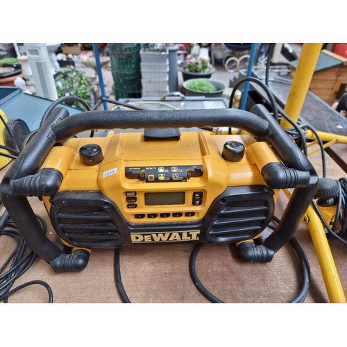 882 - Three items, one DeWalt DC013 240v radio, one DeWalt DW677 240v sander and one pair of 240v work lig... 