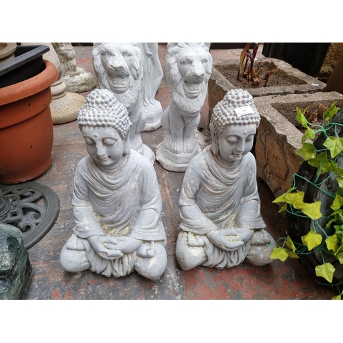 932 - Two grey painted fibre glass buddha garden ornaments