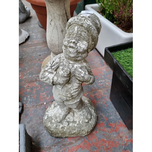 933 - A cast stone garden ornament in the form of a man with top hat