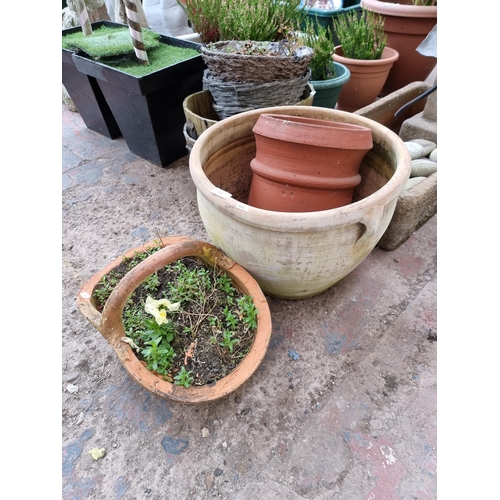 942 - Four planters, three terracotta and one glazed