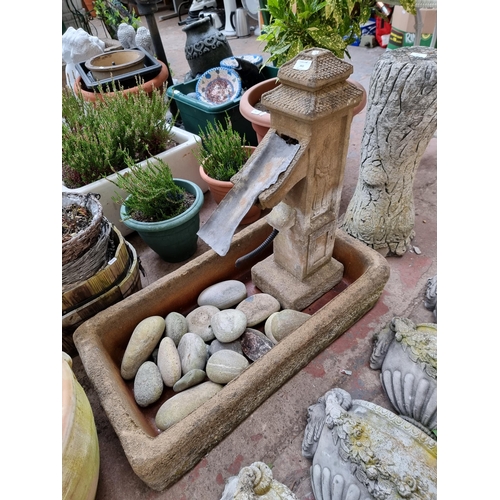 943 - Two Sandstone garden items, one trough and one Oriental style water feature