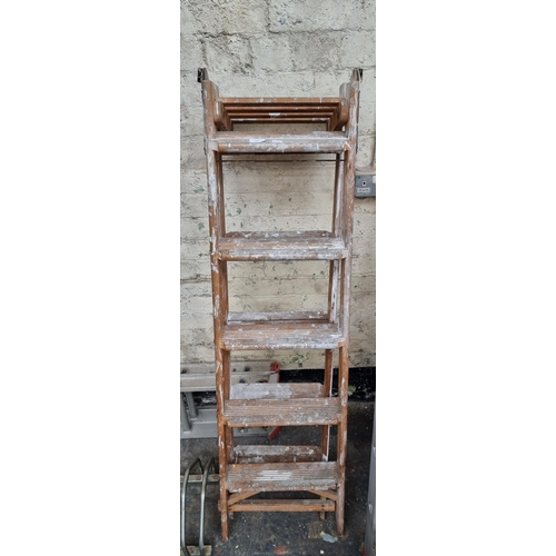 814 - A pair of wooden five tread step ladders