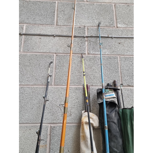 816 - A collection of fishing tackle to include eight rods, soft plastic lures, tackle boxes, spoons, hook... 