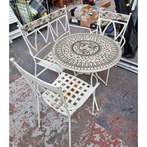 842 - A cream painted metal and mosaic four piece patio set comprising two armchairs, two seater bench and... 