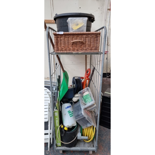 843 - A collection of garden equipment and tools to include Hozelock boxed four shelf greenhouse etc. (cag... 