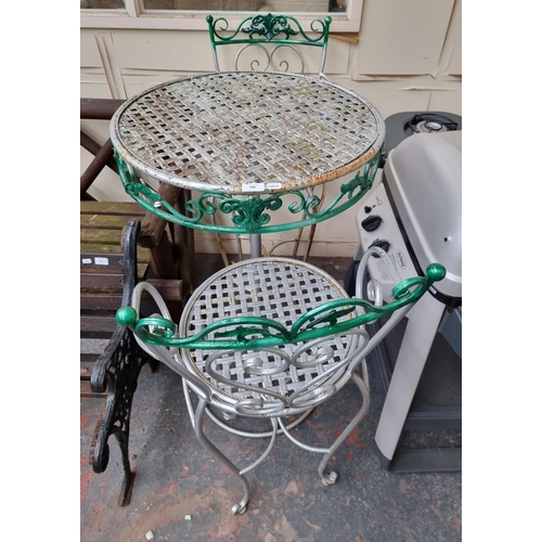 846 - A three piece tubular metal garden patio set comprising two chairs and circular table