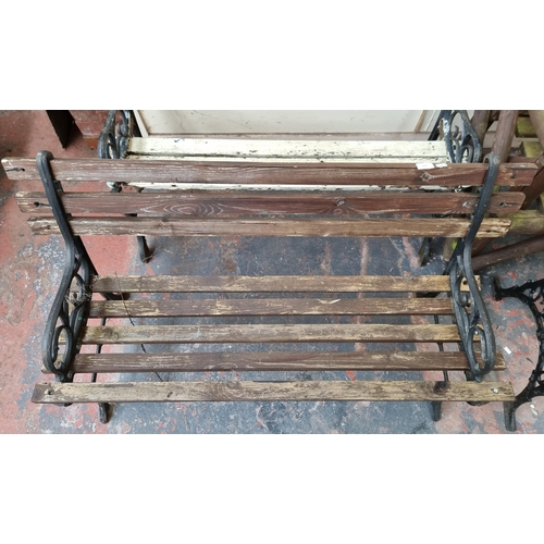 850 - A cast iron and wooden slatted garden bench