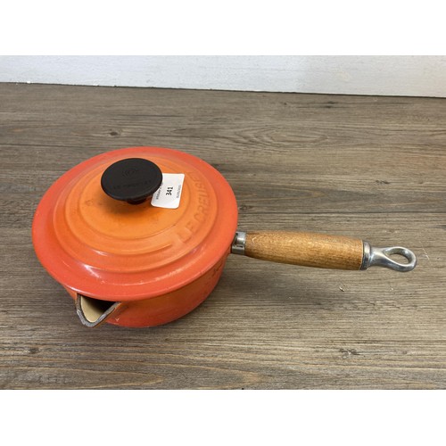 341 - Four Le Creuset orange enamel and cast iron graduating saucepans, no. 16, 18, 20 and 22