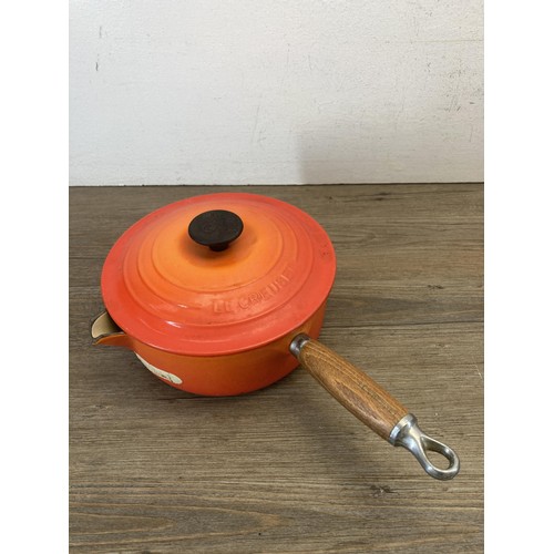 341 - Four Le Creuset orange enamel and cast iron graduating saucepans, no. 16, 18, 20 and 22