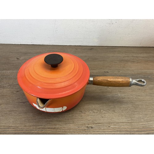 341 - Four Le Creuset orange enamel and cast iron graduating saucepans, no. 16, 18, 20 and 22