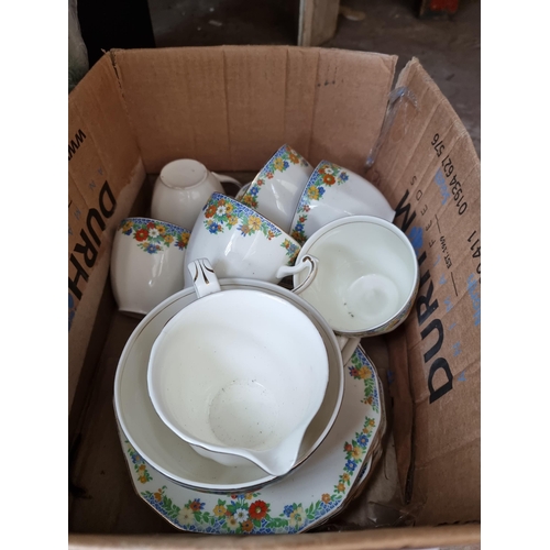 960A - Five boxes containing assorted items to include ceramics, glassware, wall lights etc.