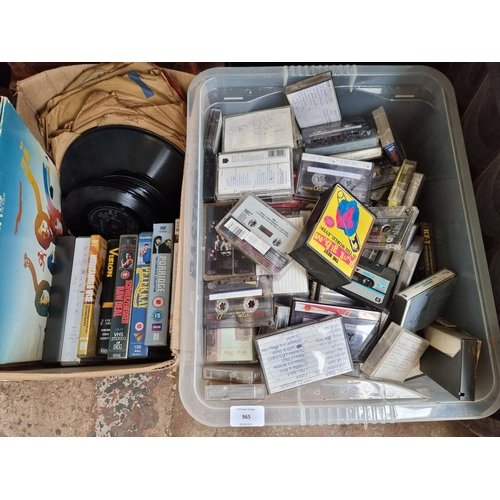 965 - Four boxes and two bags containing a large quantity of mixed media to include cassette tapes, VHS ta... 