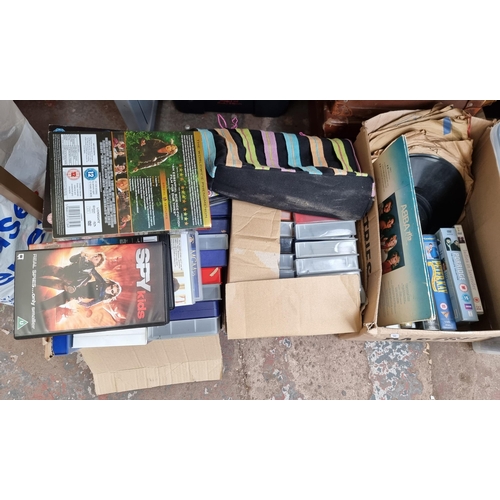 965 - Four boxes and two bags containing a large quantity of mixed media to include cassette tapes, VHS ta... 