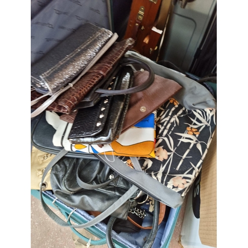 966 - Three suitcases containing handbags, purses etc.