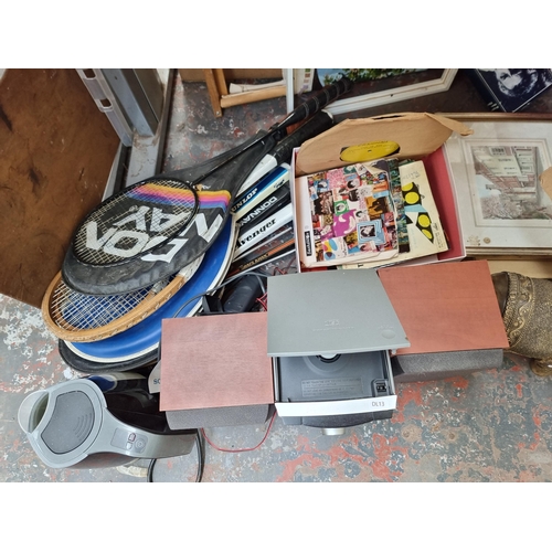 967 - A collection of house clearance items to include tennis and badminton rackets, framed prints, resin ... 