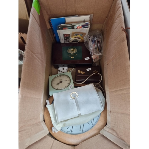 978 - Five boxes containing books, kitchenware, stamps, Westclox electric alarm clock etc.