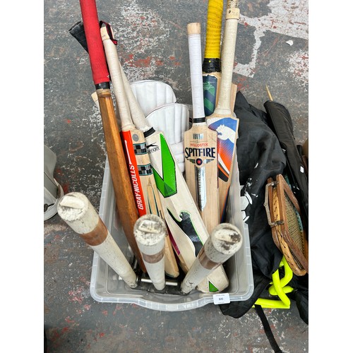 820 - A collection of sport equipment to include cricket bats, pads and stumps, 20kg weight training bags,... 