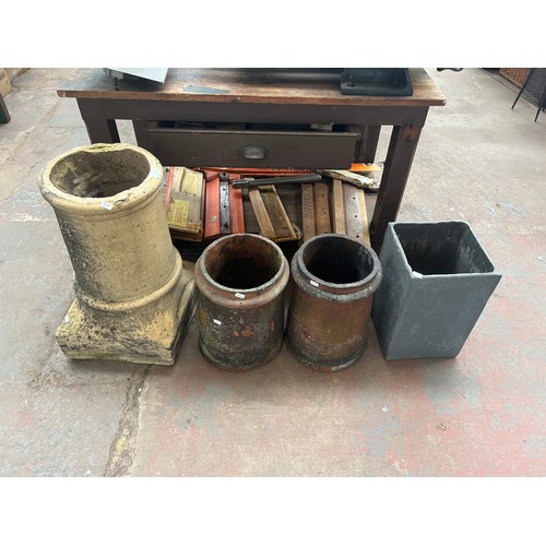 957 - Four garden items, three Victorian chimney pots and one fibre glass planter