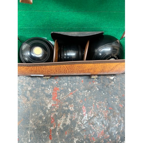 828 - A set of three cased Thomas Taylor 2-10 bowls