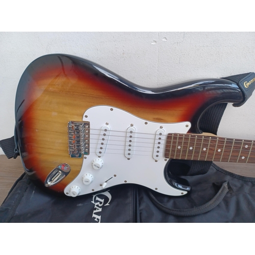 669 - A cased Crafter Cruiser sunburst Stratocaster style electric guitar with strap, pitch pipe and tremo... 