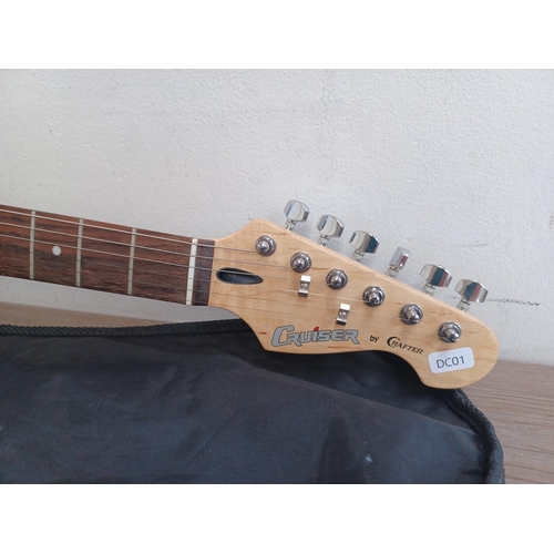 669 - A cased Crafter Cruiser sunburst Stratocaster style electric guitar with strap, pitch pipe and tremo... 