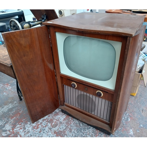 683A - A mid 20th century Bush T.U.G 59 television in walnut cabinet on castors