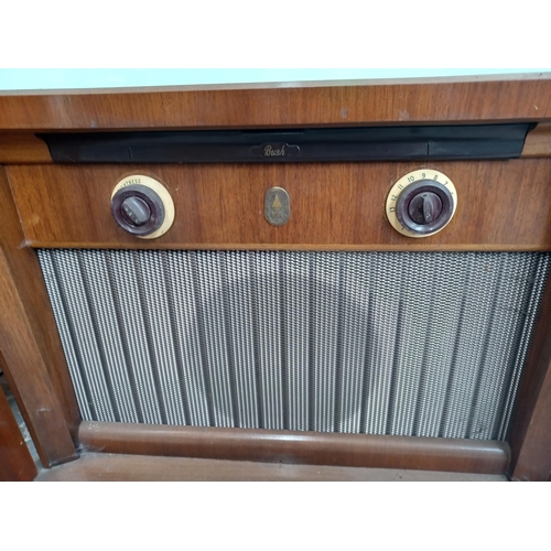 683A - A mid 20th century Bush T.U.G 59 television in walnut cabinet on castors