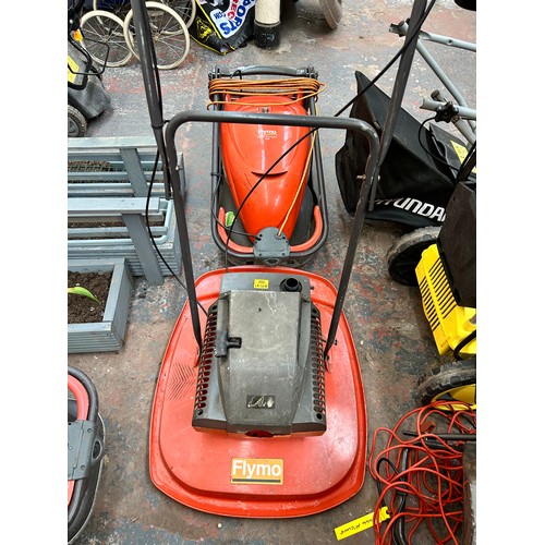 916 - Two Flymo lawn mowers, one petrol and one 240v