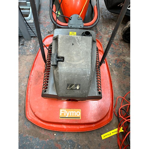 916 - Two Flymo lawn mowers, one petrol and one 240v