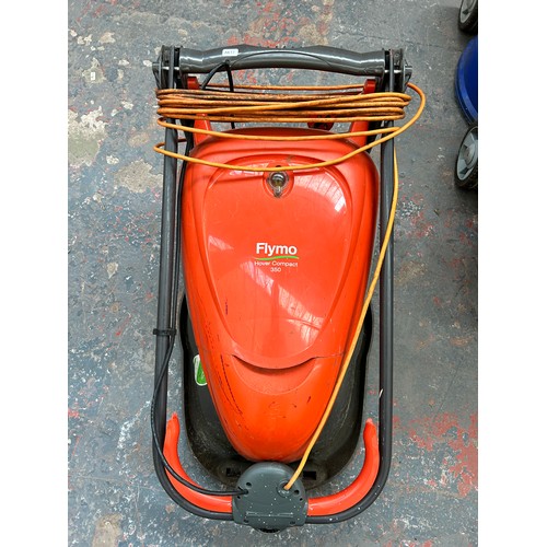 916 - Two Flymo lawn mowers, one petrol and one 240v