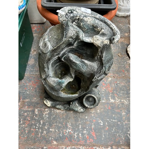 935 - A collection of garden items to include fibre glass water feature with pump, scalloped bird bath on ... 