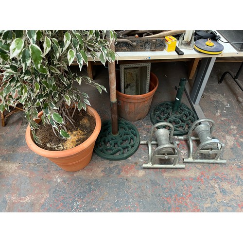 960C - Seven items to include two Victorian style green painted cast iron parasol bases, two heavy duty cab... 