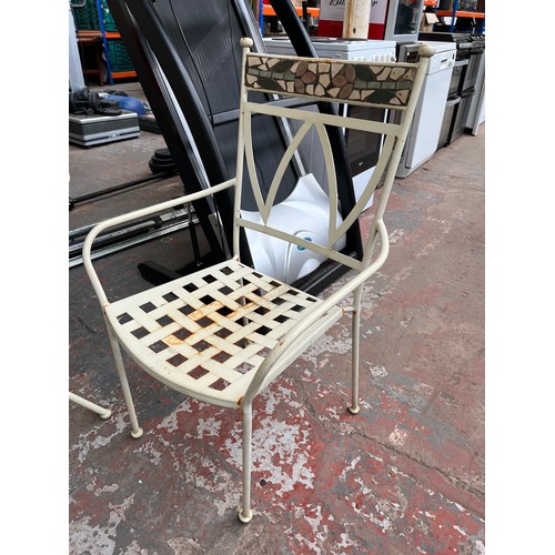 842 - A cream painted metal and mosaic four piece patio set comprising two armchairs, two seater bench and... 