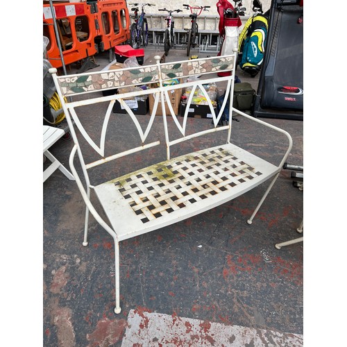 842 - A cream painted metal and mosaic four piece patio set comprising two armchairs, two seater bench and... 