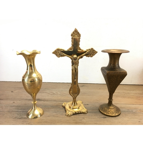 306A - A collection of metalware to include Indian brass vase, copper vase, brass crucifix etc.