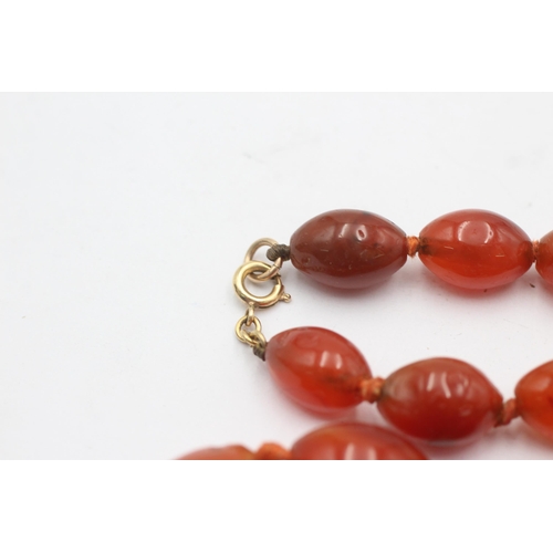 1004 - A graduated carnelian beaded necklace with 9ct gold clasp - approx. gross weight 87.4 grams