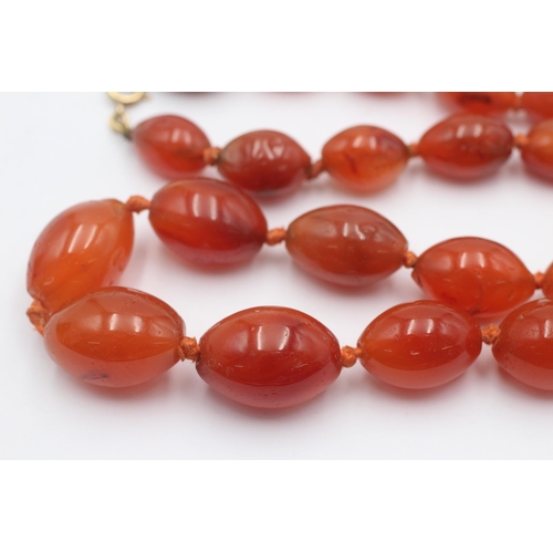 1004 - A graduated carnelian beaded necklace with 9ct gold clasp - approx. gross weight 87.4 grams