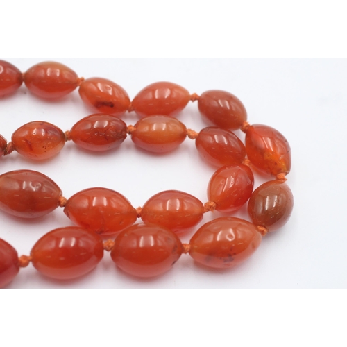 1004 - A graduated carnelian beaded necklace with 9ct gold clasp - approx. gross weight 87.4 grams