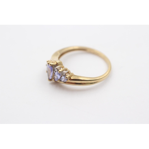 1008 - A 9ct gold diamond and tanzanite eight stone bypass ring - approx. gross weight 2.4 grams