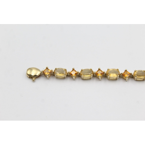 1012 - A 9ct gold citrine and topaz tennis chain bracelet - approx. gross weight 6.4 grams