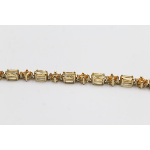 1012 - A 9ct gold citrine and topaz tennis chain bracelet - approx. gross weight 6.4 grams