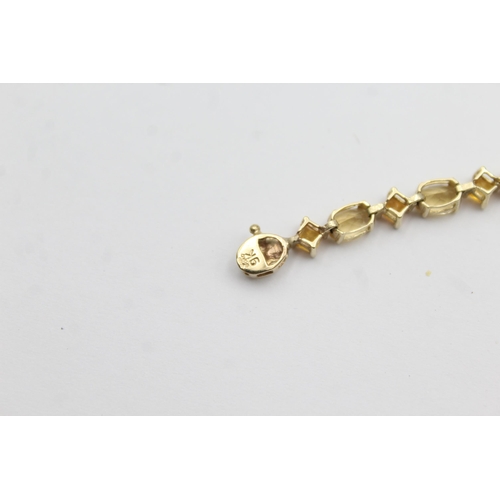 1012 - A 9ct gold citrine and topaz tennis chain bracelet - approx. gross weight 6.4 grams