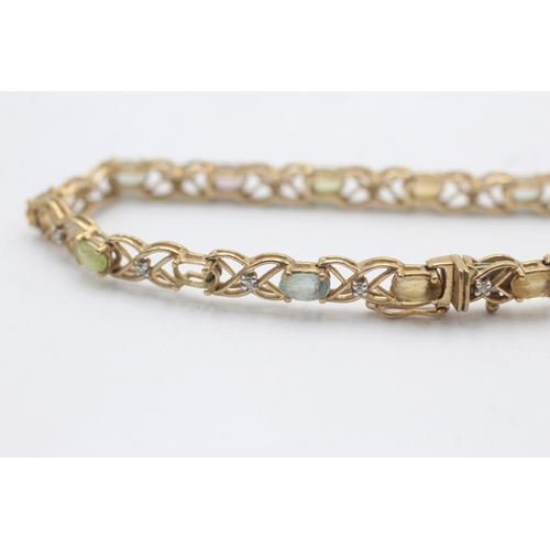 1014 - A 9ct yellow and white gold diamond, topaz, citrine and peridot fancy chain bracelet - approx. gross... 